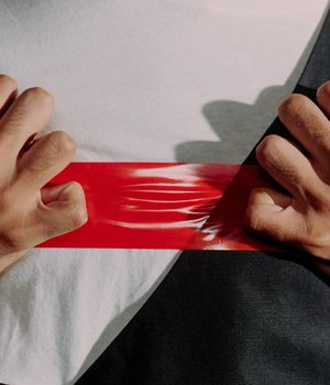 Close-up of a man's hands gripping a weight, showing focus.