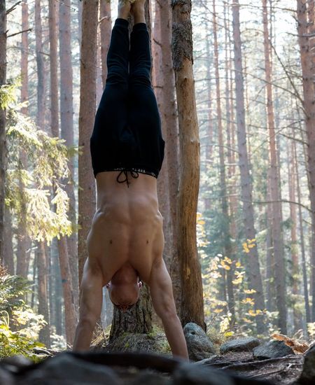 Man performing a controlled strength exercise in a calm environment.